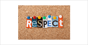 Colorful letters spelling 'RESPECT' pinned on a corkboard.
